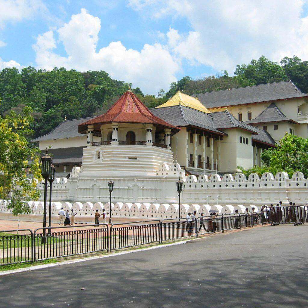 The Temple of the Tooth (Sri Dalada Maligawa) in Kandy under a blue sky