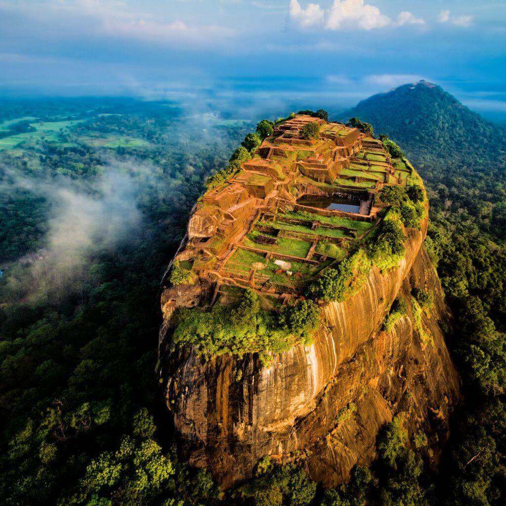 Sigiriya rock fortress rising out of the forest, seen from the air