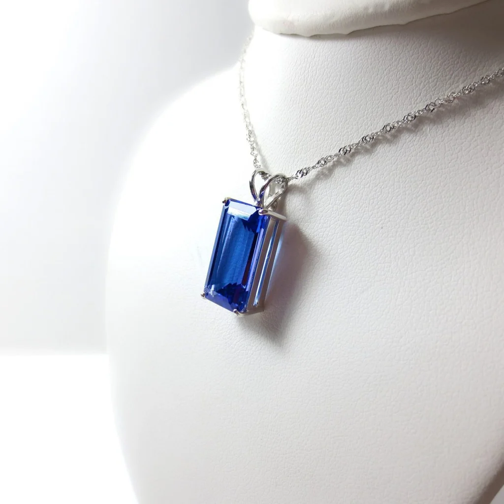 A blue tanzanite pendant on a silver chain