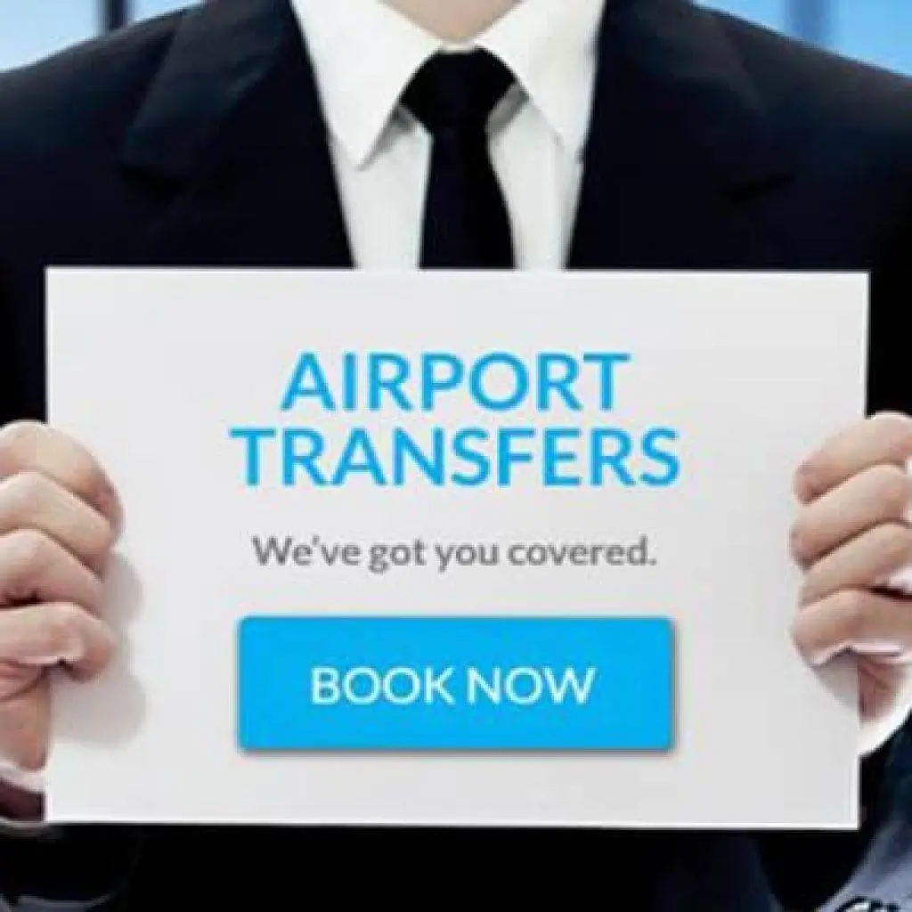 A driver holding an Airport Transfers sign with a Book Now button