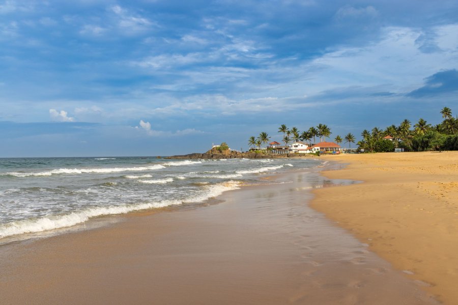 Wide sandy beach and waves at Bentota