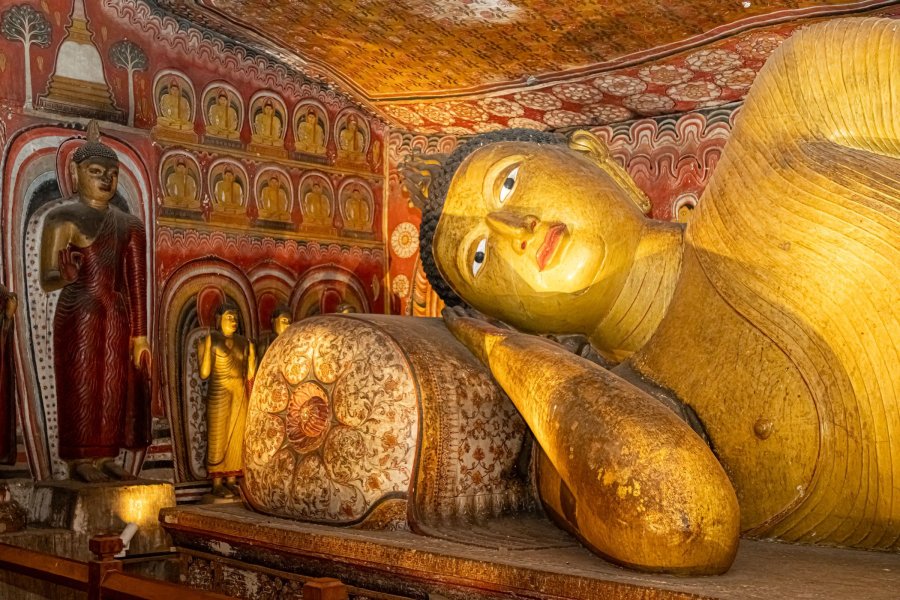 Reclining Buddha and painted ceiling inside the Dambulla cave temple