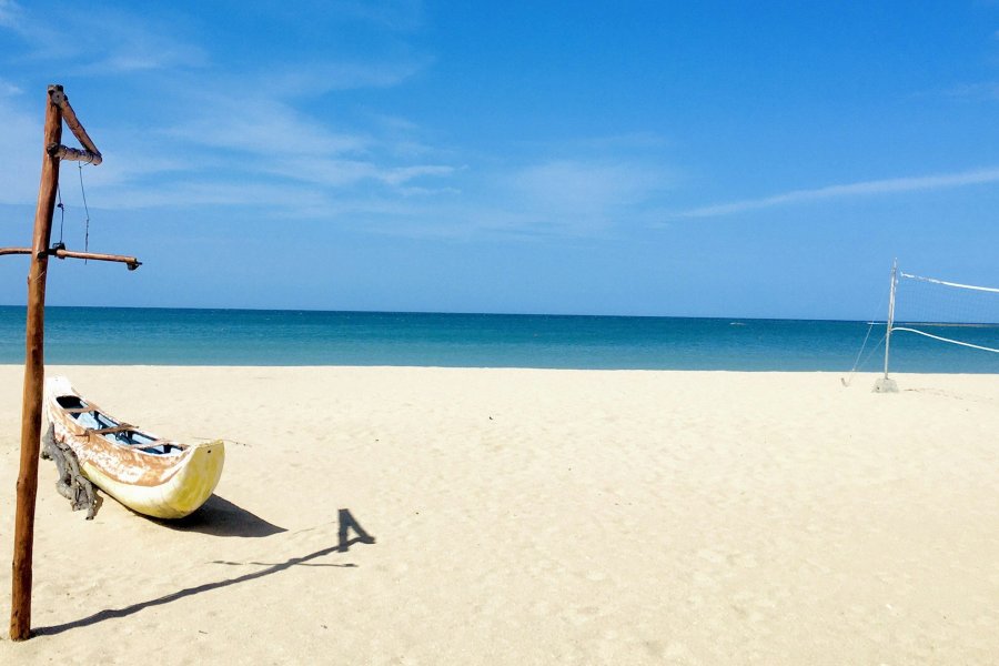 A fishing boat on the white sand of Pasikudah beach