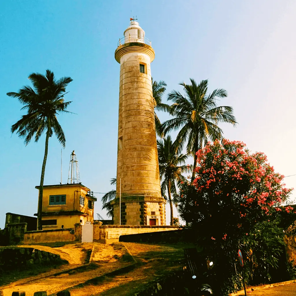 The Galle Fort lighthouse among palm trees