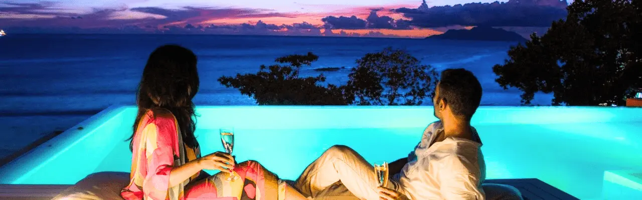 Couple by a pool at sunset in Sri Lanka